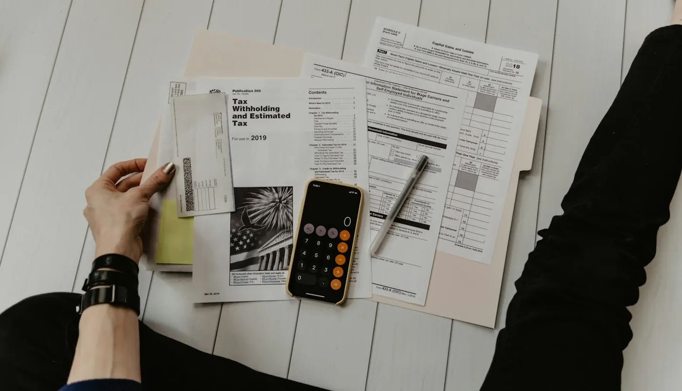 Accounting documents, calculator and paperwork on a desk