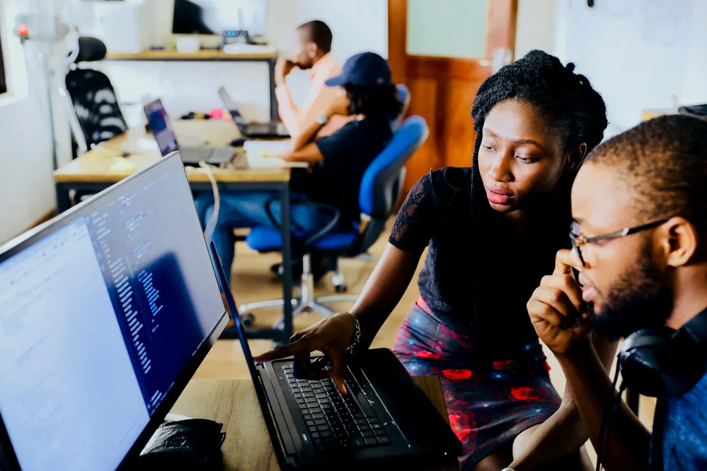 IT professionals working together at a computer in an office